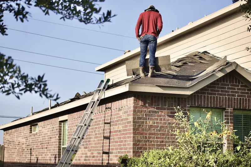 Professional roofer working on a residential roof in Locust Hill Estates